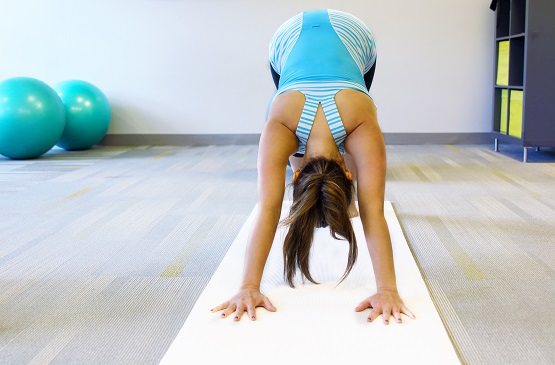 young beautiful female doing yoga inside a gym